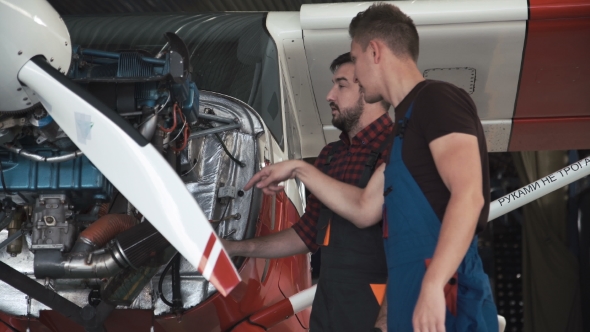 Two Flight Mechanics Doing a Pre Flight Check