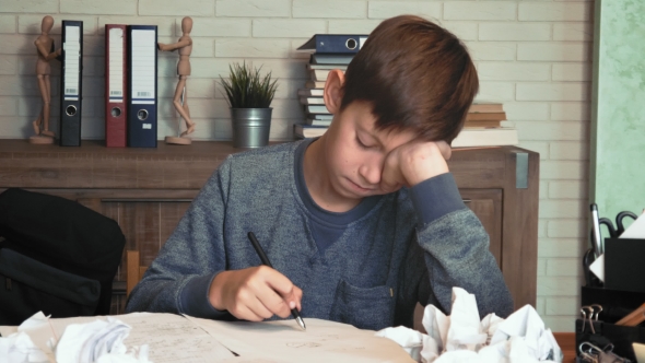 Frustrated Little Boy Tired of His Homework Crumples His Paper
