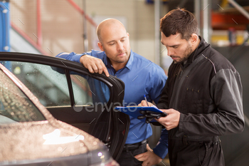 pt – mechanic with clipboard and customer or car owner at workshop