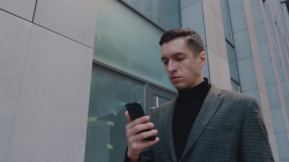 Confident Businessman Using Mobile Phone