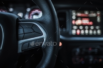 r Steering Wheel Covered By Leather and Multimedia Dashboard in the Background.