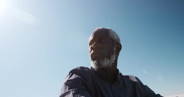 Senior man sitting on the sand