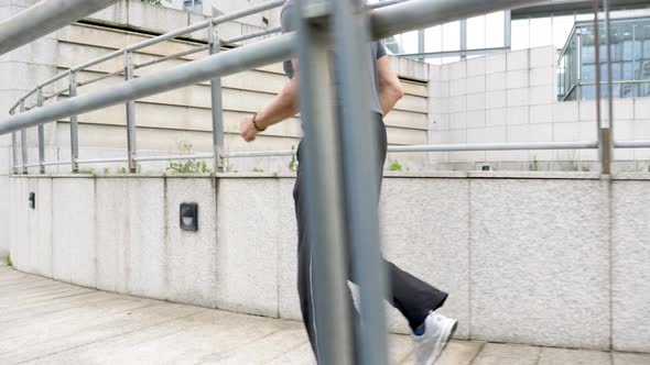 Slow motion shot of senior man jogging in city