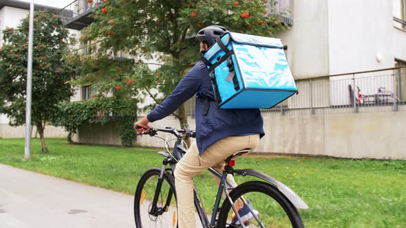 Indian Delivery Man with Bag Riding Bicycle