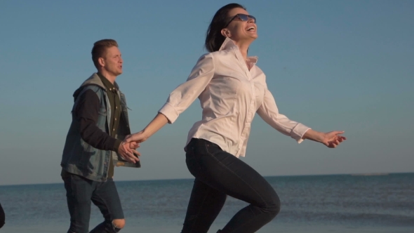 Laughing Youth Running on Shoreline