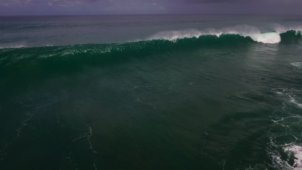 Aerial Drone Footage of Ocean Waves Breaking Before the Shore in Bali, Indonesia