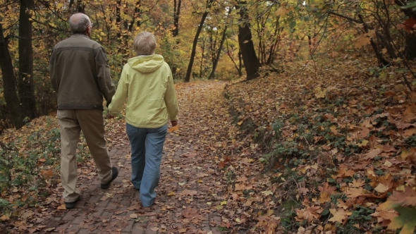 Senior Couple Enjoys Romantic Walk in Autumn Park