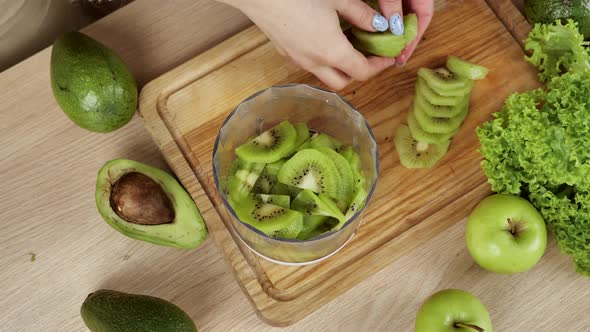 Closeup Top View Tossing Thinly Sliced Kiwi Slices Into Blender