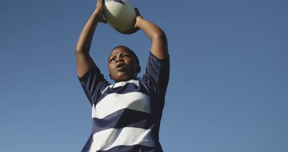 Young adult female rugby player on a rugby pitch