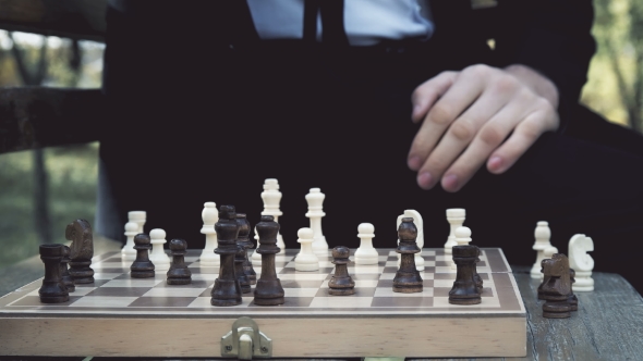 Man in Suit Playing Chess in the Autumn Park