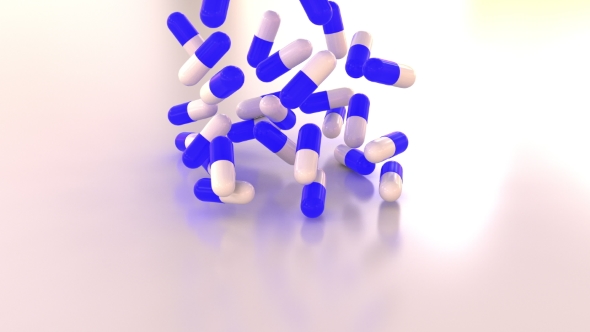 Blue and White Drug Capsules or Pills Scatter on the Table alt