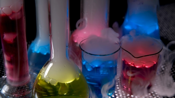 Test Tubes with Chemical Liquid in Laboratory on Black Background alt