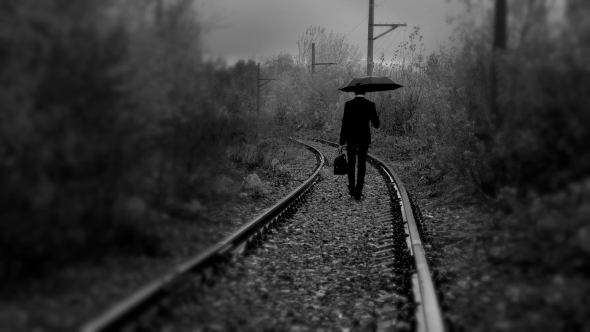 Man with Umbrella Walking on Railroad,black and White Color