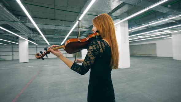 Professional Musician Plays Violin, Standing Alone in a Room.