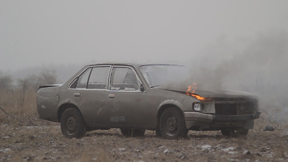 Burning Car in the Open Field