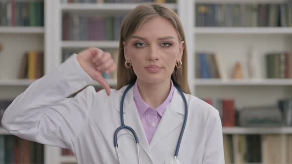 Portrait of Lady Doctor Showing Thumbs Down Gesture