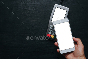 smartphone. Clear white mockup screen template of phone and pos terminal on dark wooden desk with side copy space