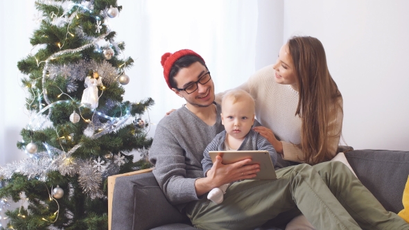 Happy Family Using Digital Tablet on Christmas Day.