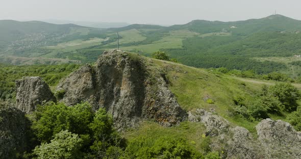 Dolly out drone shot of a natural landscape around the Azeula Fortress.