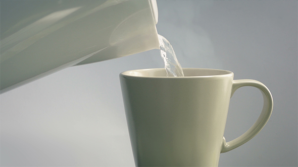 Drink Making - Kettle Pours Boiling Water Into Cup