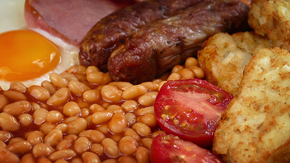 Cooked Breakfast With Sausages, Egg, Beans, Bacon And Hash Browns