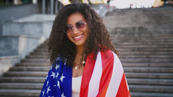 Young Afro American Female in White Outfit and Sunglasses
