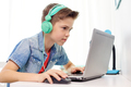boy in headphones playing video game on laptop - PhotoDune Item for Sale