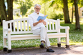 happy senior man reading book at summer park - PhotoDune Item for Sale