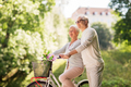 happy senior couple with bicycle at summer park - PhotoDune Item for Sale