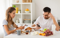couple with smartphones having breakfast at home - PhotoDune Item for Sale