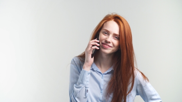 Young Attractive Redhead Girl Talking By Phone With Friend And Smiling.