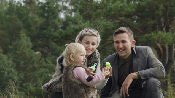 Kid Happiness, Family Rest on the Nature, Blowing and Catching Bubbles