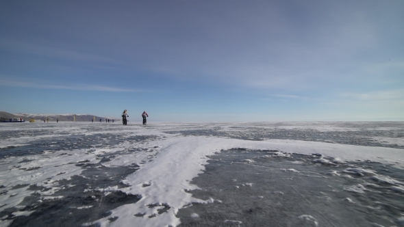 a Man Riding a Bicycle Across a Frozen Lake