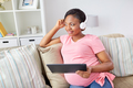 pregnant woman in headphones with tablet pc - PhotoDune Item for Sale