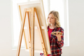 student girl with easel painting at art school - PhotoDune Item for Sale