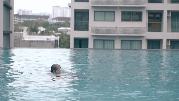 Dad with Cute Girl Rests in Empty Hotel Pool Slow Motion