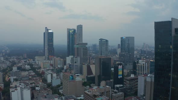 Ascending Aerial View of Tall Modern Skyscrapers in Mexico City Center in Blue Evening Light