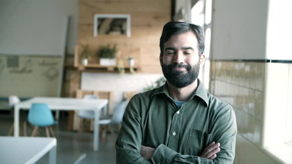 Cheerful Hispanic Young Man with Crossed Arms