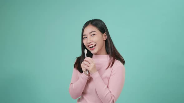 woman smile toothbrush instead microphone dancing