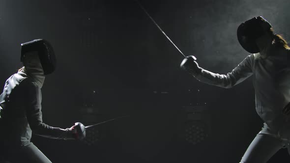 Footage of Two Fencing Athletes Duel . Two Professional Fencers Show Masterful Swordsmanship in