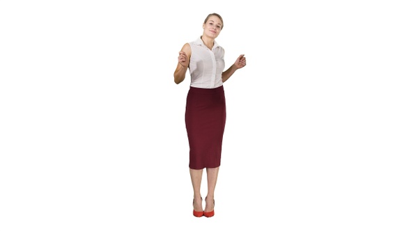 Beautiful happy young business woman dancing on white background