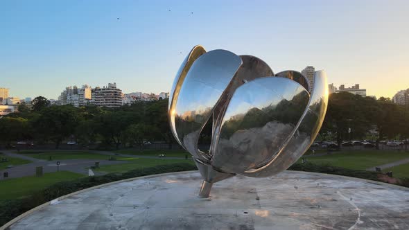 Aerial orbiting view of the Floralis Generica sculpture in Buenos Aires at dusk