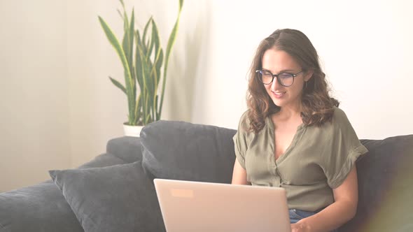 A Young Woman Wearing Glasses Using Laptop Computer for Communicating Online