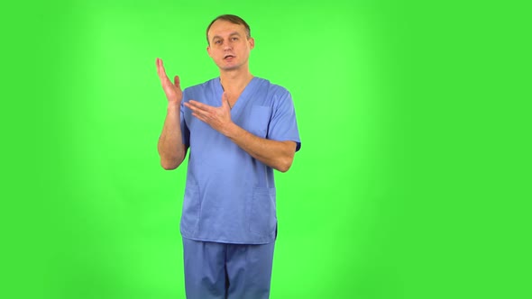 Medical Man Talking and Pointing Side Hand for Something, Copy Space. Green Screen