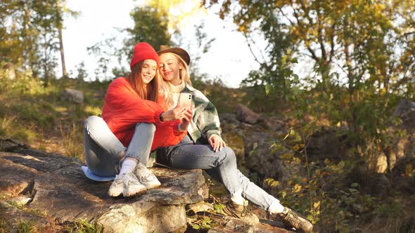 Caucasian Friends Rest on Mountains Use Smartphone