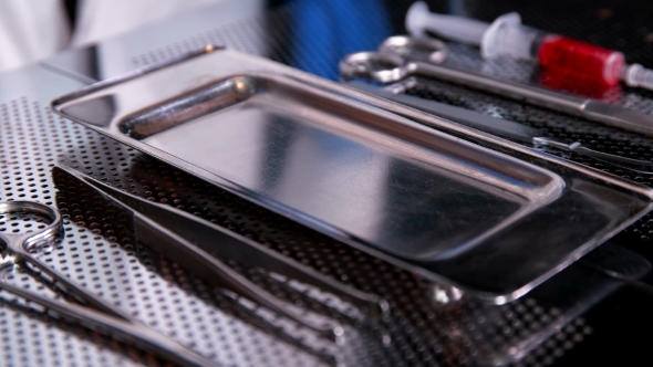 the Surgeon Puts a Flash Chip on the Tray After Surgery