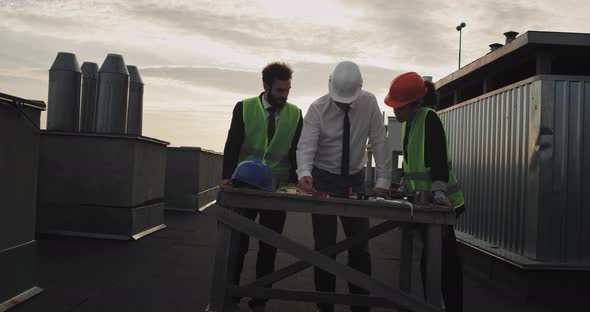 Three Architects Work on Some Blue Prints