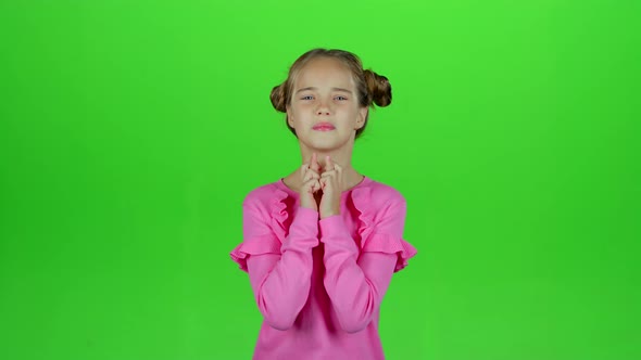 Child Crosses His Fingers, She Hopes To Win. Green Screen. Slow Motion