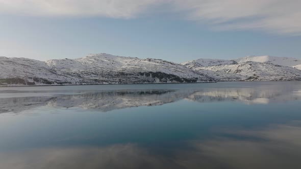 Snowy Mountains With Blue Sky Reflections On Beautiful Calm Lake In Dafjord, Ringvassoya, Northern N