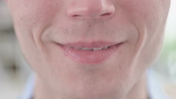 Close Up of Smiling Young Man Lips and Teeth